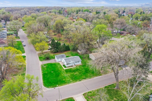 birds eye view of property featuring a wooded view