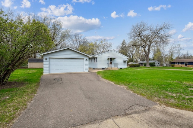 exterior space with a garage, a yard, and driveway