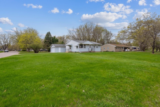 exterior space featuring a garage and an outbuilding