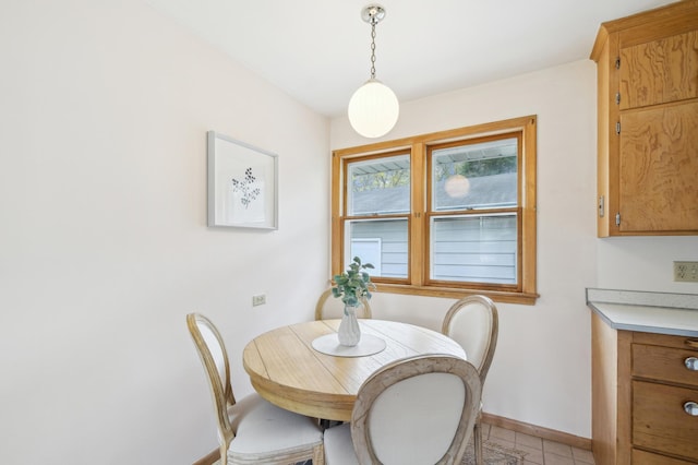dining room featuring baseboards and light tile patterned flooring