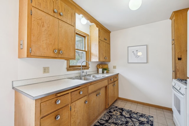 kitchen with light countertops, baseboards, white gas range oven, and a sink
