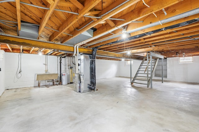 basement featuring a sink, heating unit, and stairs