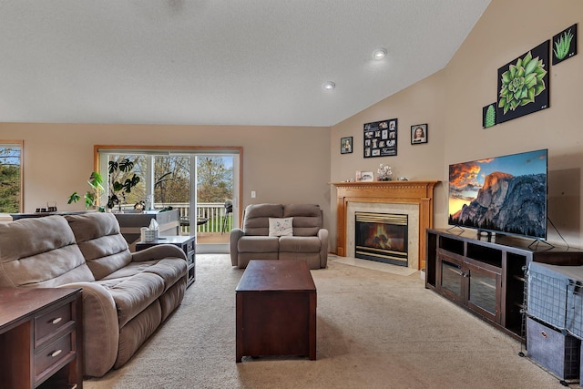 living area with recessed lighting, a fireplace with flush hearth, carpet, and lofted ceiling