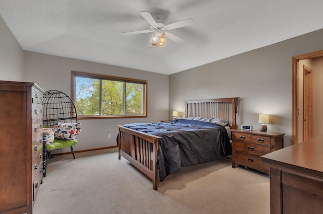 bedroom with a ceiling fan, baseboards, and light carpet