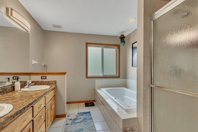 bathroom with a sink, tile patterned floors, a jetted tub, a shower stall, and visible vents