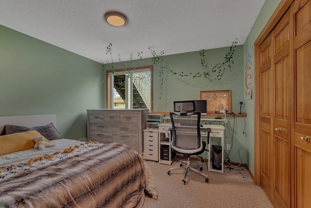 carpeted bedroom with a textured ceiling