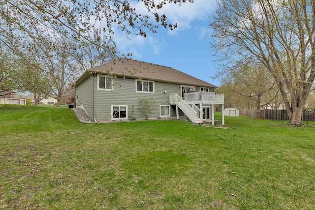 rear view of house with an outdoor structure, a wooden deck, stairs, a storage shed, and a yard