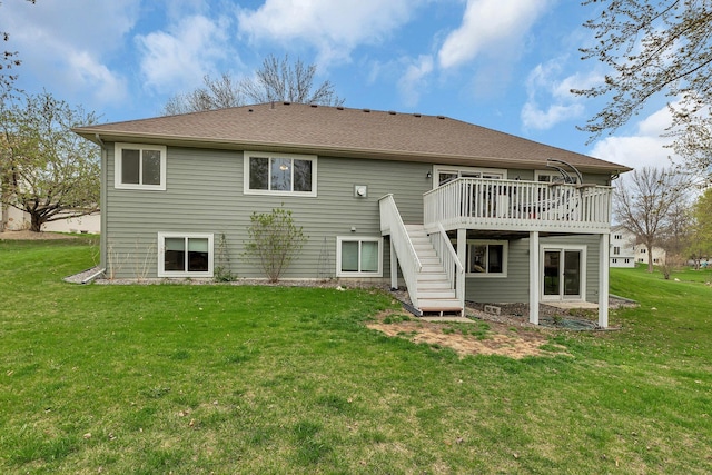 back of house featuring a lawn, a wooden deck, and stairway