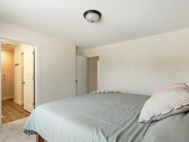 bedroom featuring baseboards and wood finished floors