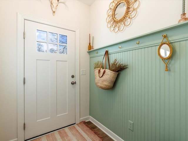 mudroom with baseboards and wood finished floors