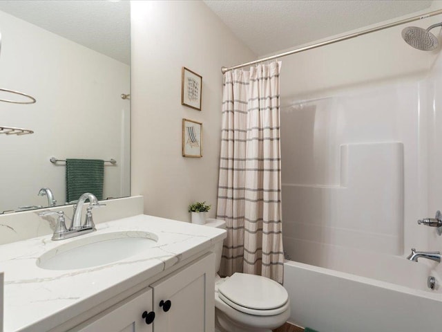 bathroom with vanity, shower / bathtub combination with curtain, toilet, and a textured ceiling