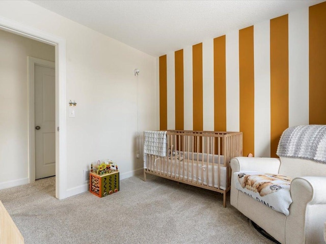 carpeted bedroom with baseboards and wallpapered walls