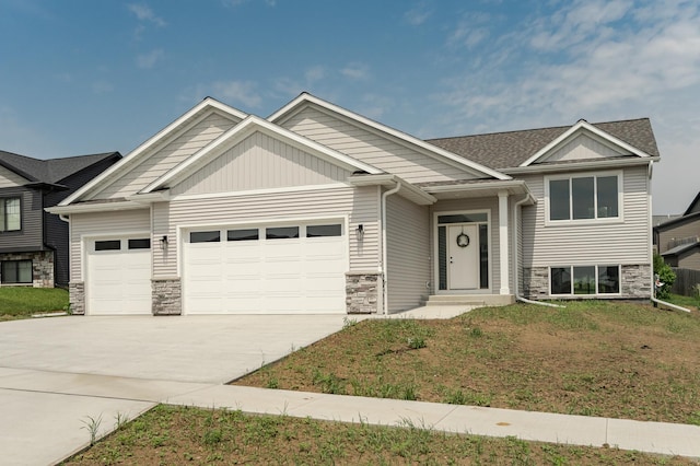 1812 Brandt Dr NE, Byron, MN 55920 - view of front of home with an attached garage, stone siding, concrete driveway, and a front lawn