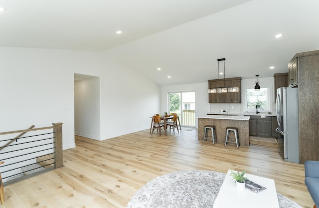 1812 Brandt Dr NE, Byron, MN 55920 - living area with light wood-type flooring, vaulted ceiling, and recessed lighting