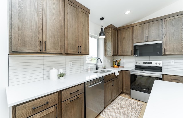 1812 Brandt Dr NE, Byron, MN 55920 - kitchen featuring stainless steel appliances, tasteful backsplash, light countertops, decorative light fixtures, and vaulted ceiling