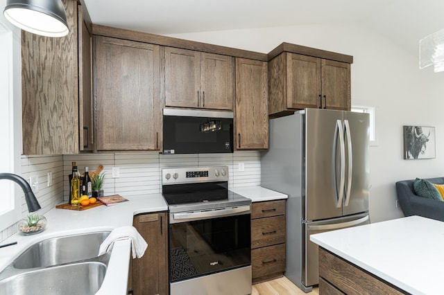 1812 Brandt Dr NE, Byron, MN 55920 - kitchen featuring stainless steel appliances, tasteful backsplash, vaulted ceiling, and light countertops