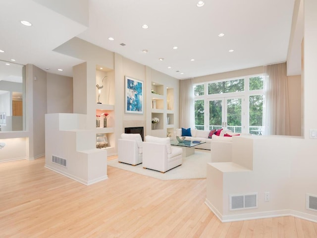 2673 Cedar Grn, Minnetonka, MN 55305 - living room with built in features, light wood-style flooring, a glass covered fireplace, recessed lighting, and baseboards