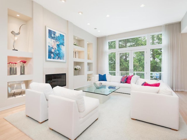 2673 Cedar Grn, Minnetonka, MN 55305 - living area with built in shelves, a glass covered fireplace, wood finished floors, recessed lighting, and baseboards