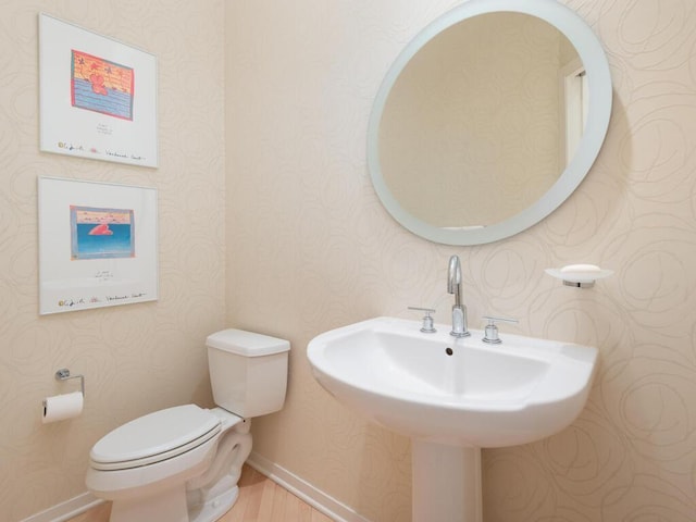 2673 Cedar Grn, Minnetonka, MN 55305 - half bathroom featuring wallpapered walls, toilet, wood finished floors, a sink, and baseboards