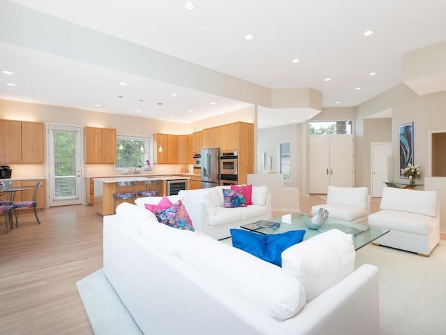 2673 Cedar Grn, Minnetonka, MN 55305 - living area featuring recessed lighting, healthy amount of natural light, wine cooler, and light wood-style flooring
