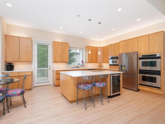2673 Cedar Grn, Minnetonka, MN 55305 - kitchen with appliances with stainless steel finishes, wine cooler, light wood-style flooring, light countertops, and recessed lighting