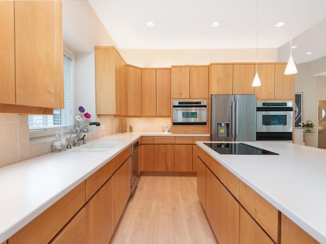 2673 Cedar Grn, Minnetonka, MN 55305 - kitchen with appliances with stainless steel finishes, a sink, light wood finished floors, backsplash, and hanging light fixtures