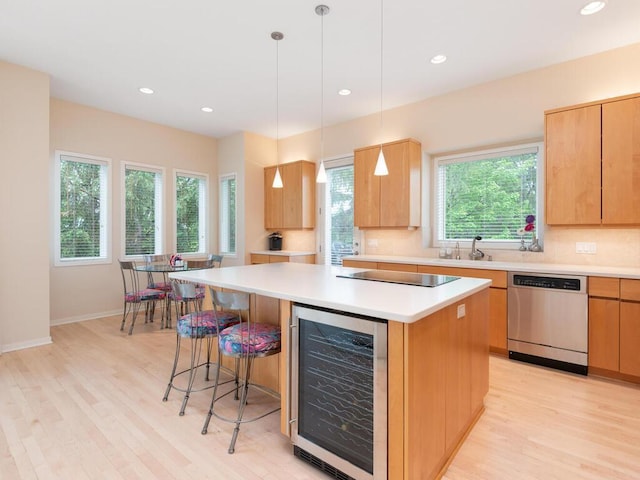 2673 Cedar Grn, Minnetonka, MN 55305 - kitchen featuring dishwasher, wine cooler, a kitchen island, a breakfast bar, and light wood-type flooring