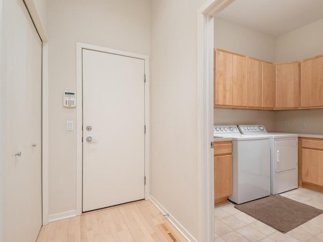 2673 Cedar Grn, Minnetonka, MN 55305 - laundry room with cabinet space, washing machine and clothes dryer, and baseboards