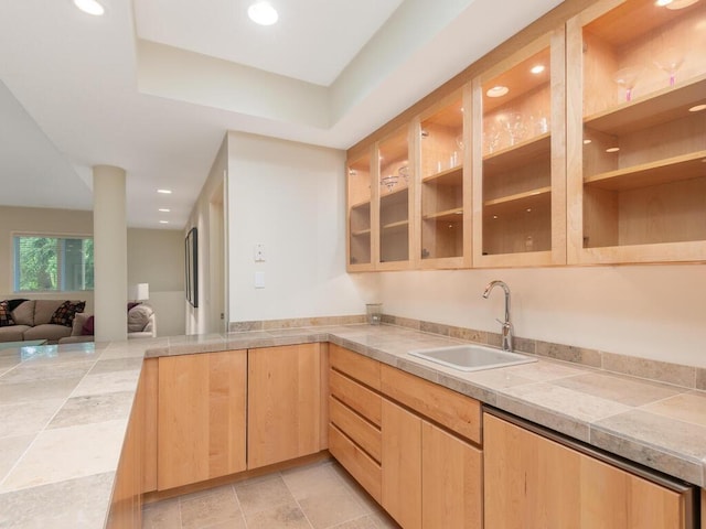 2673 Cedar Grn, Minnetonka, MN 55305 - kitchen featuring a sink, light brown cabinets, open floor plan, glass insert cabinets, and a peninsula