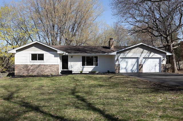 ranch-style house with an attached garage, a front lawn, aphalt driveway, stone siding, and a chimney
