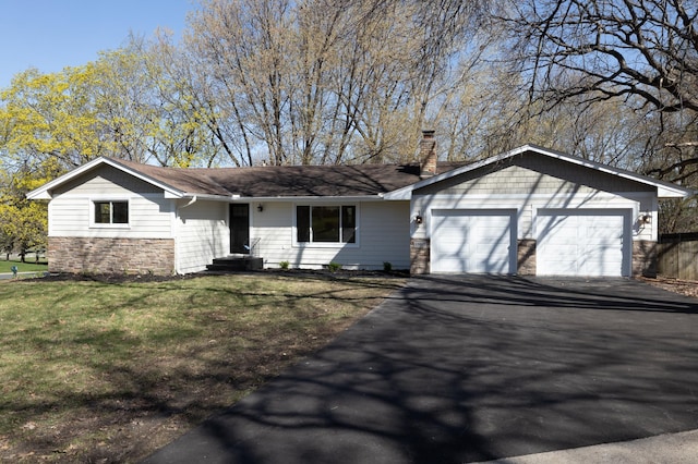 single story home featuring aphalt driveway, a chimney, a front lawn, an attached garage, and stone siding