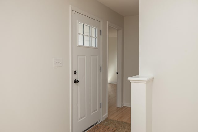 entryway featuring baseboards and wood finished floors
