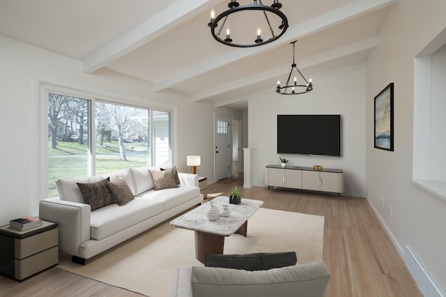 living area featuring an inviting chandelier, plenty of natural light, wood finished floors, and visible vents