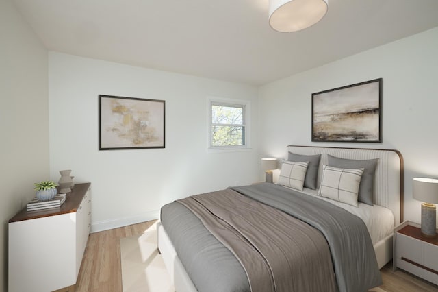 bedroom with light wood-style floors and baseboards