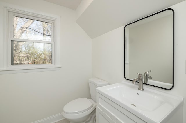bathroom with vanity, baseboards, and toilet