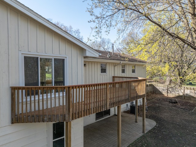wooden deck with fence and a patio area