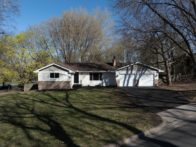 ranch-style house featuring a garage, a front lawn, a chimney, entry steps, and driveway