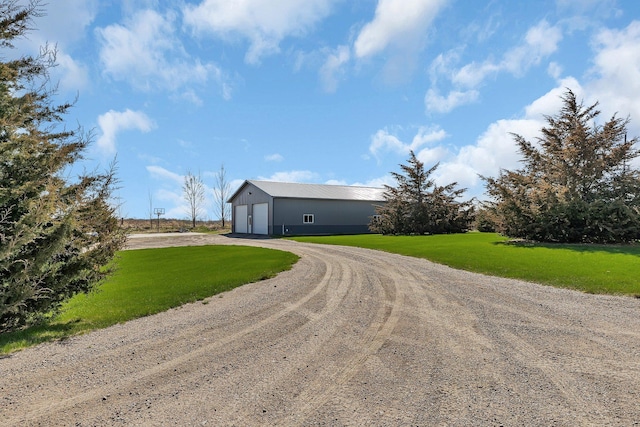 8619 State Highway 55 NW, Annandale, MN 55302 - view of front of house featuring a garage, dirt driveway, an outbuilding, and a front lawn