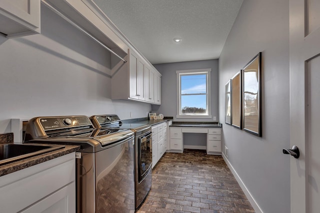 8619 State Highway 55 NW, Annandale, MN 55302 - clothes washing area with baseboards, a textured ceiling, brick floor, washing machine and clothes dryer, and cabinet space