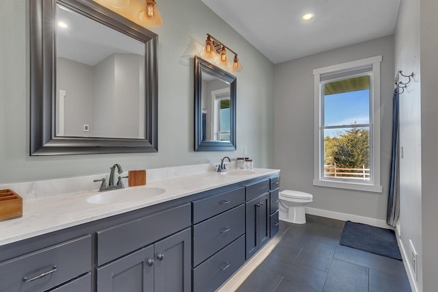 8619 State Highway 55 NW, Annandale, MN 55302 - bathroom with toilet, double vanity, baseboards, and a sink
