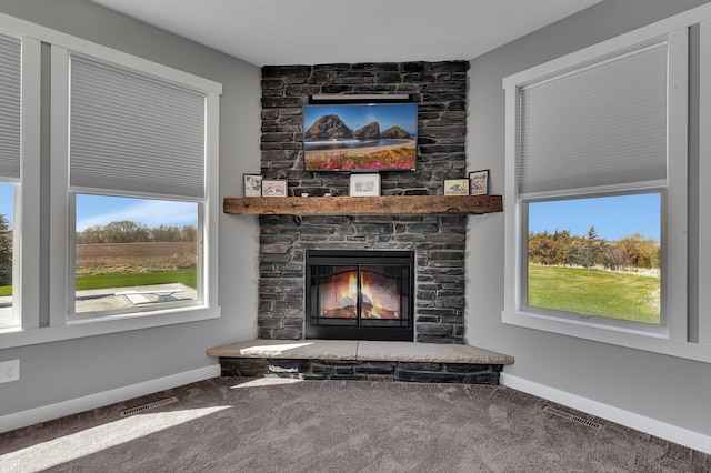 8619 State Highway 55 NW, Annandale, MN 55302 - details with baseboards, carpet flooring, a stone fireplace, and visible vents