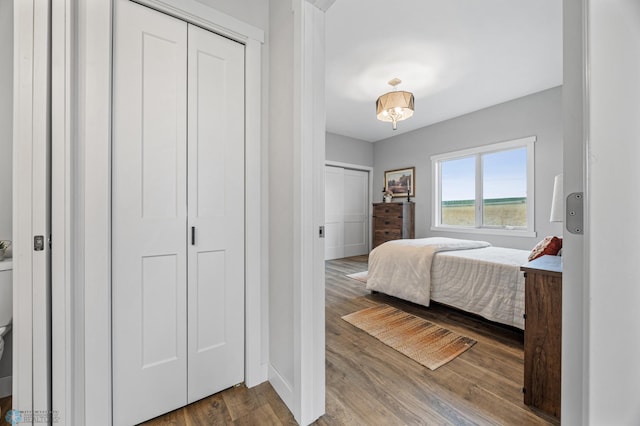 bedroom featuring baseboards and wood finished floors