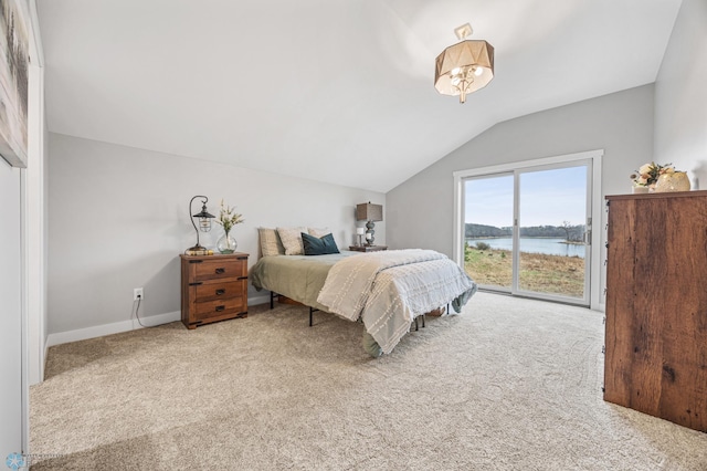 carpeted bedroom featuring baseboards, a water view, vaulted ceiling, and access to exterior