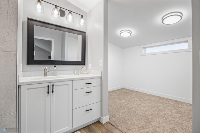 bathroom with vanity and baseboards