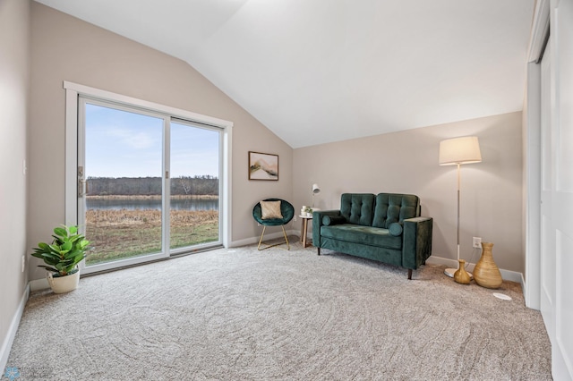 sitting room featuring baseboards, carpet, a water view, and lofted ceiling