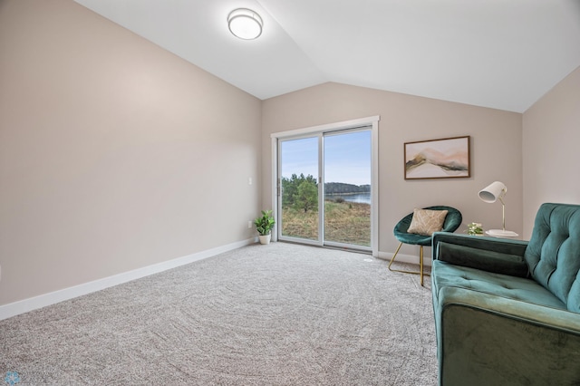 sitting room with baseboards, a water view, vaulted ceiling, and carpet flooring