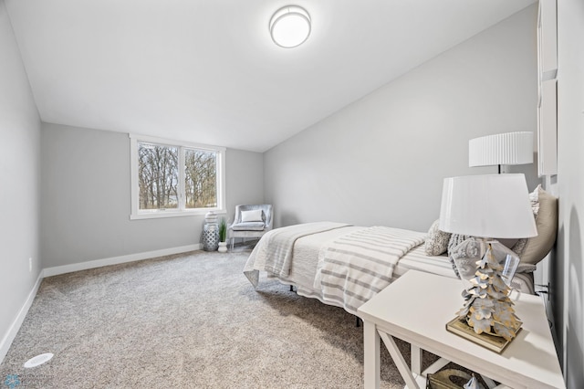 carpeted bedroom featuring baseboards and vaulted ceiling