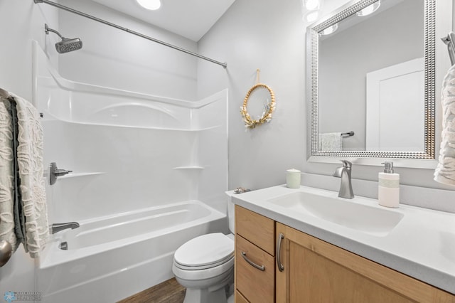 bathroom featuring vanity, wood finished floors, bathing tub / shower combination, and toilet