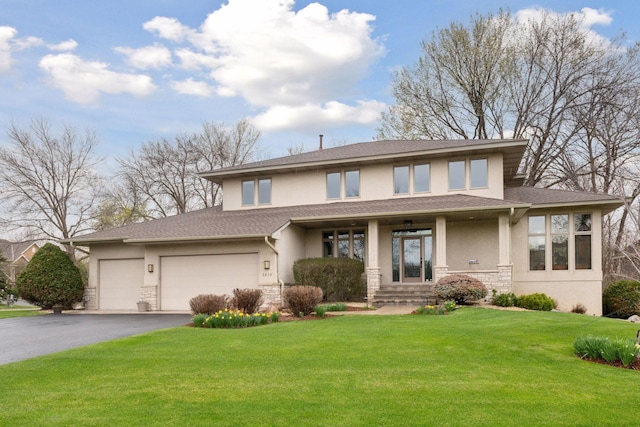 view of front of property with driveway, a front lawn, stone siding, and stucco siding