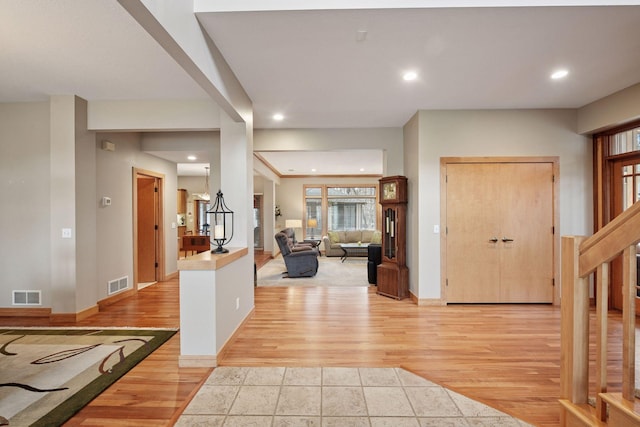 foyer entrance featuring recessed lighting, visible vents, and light wood finished floors